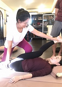 Yoga Teacher learns advanced Compression stretching to improve range of motion at hip joint