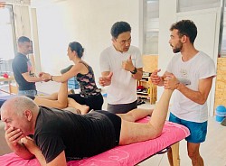 Students actively engage, posing pertinent questions on pain relief and postural correction techniques.